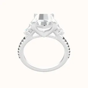 Diamond engagement ring with marquise and round diamond sidestones in a four prong head.