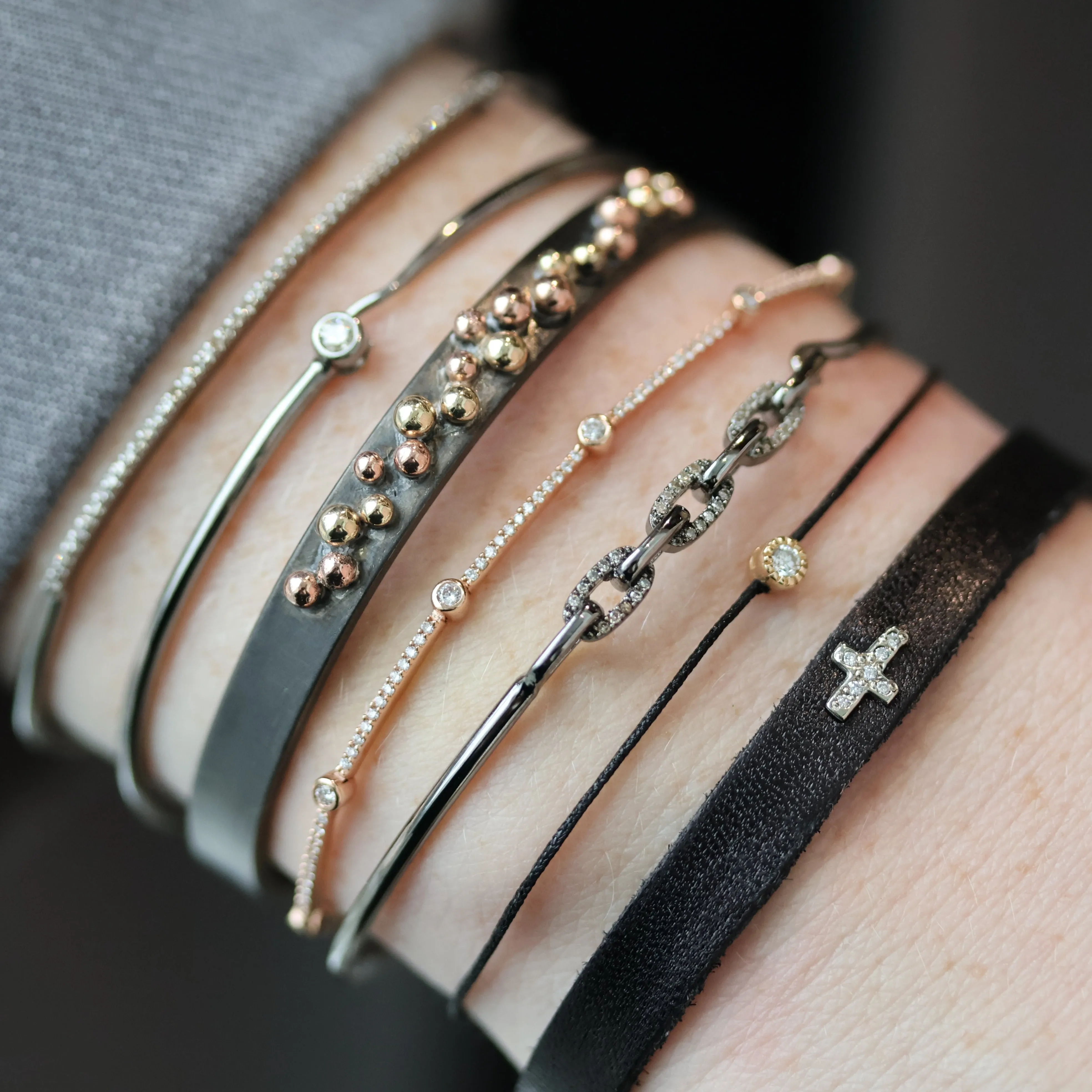 Pave Diamond Cross Leather Bracelet can be rewritten as Diamond Cross Leather Bracelet with Pave Detailing.